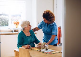 A photo of an elderly woman with a carer.